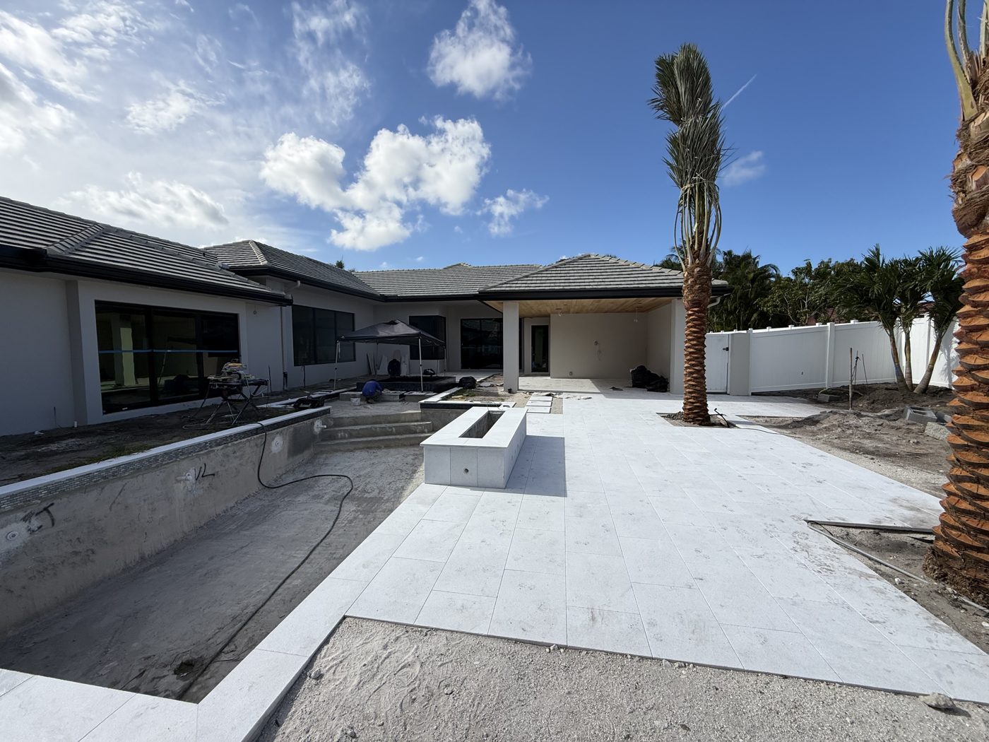 Marble deck installed around the pool shell before finishing