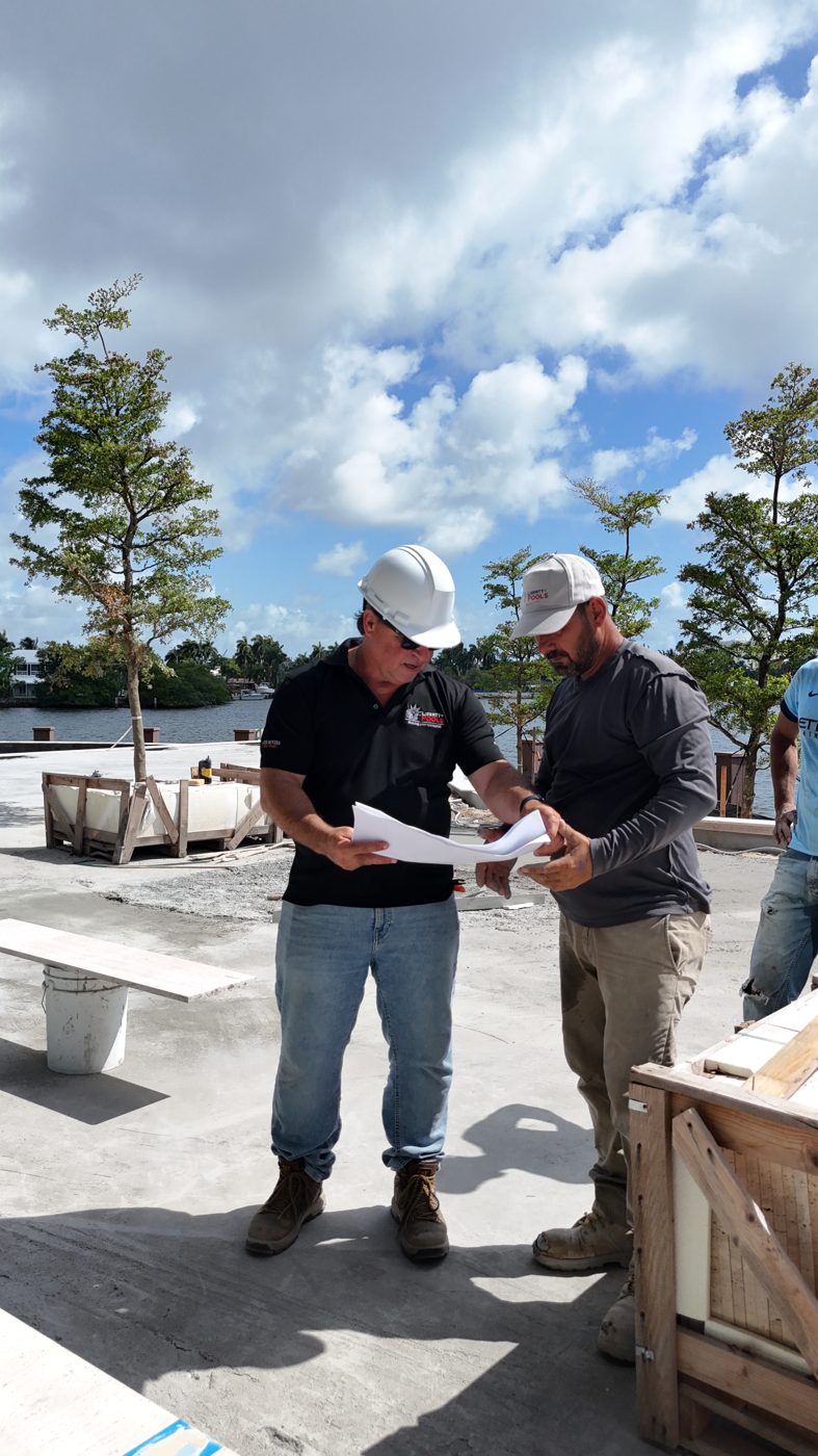 Project manager and superintendent reviewing plans on the cured shell