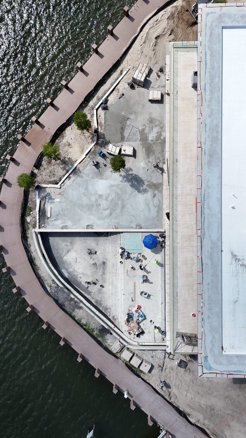 Top-down drone view of the finished concrete shell on the peninsula lot