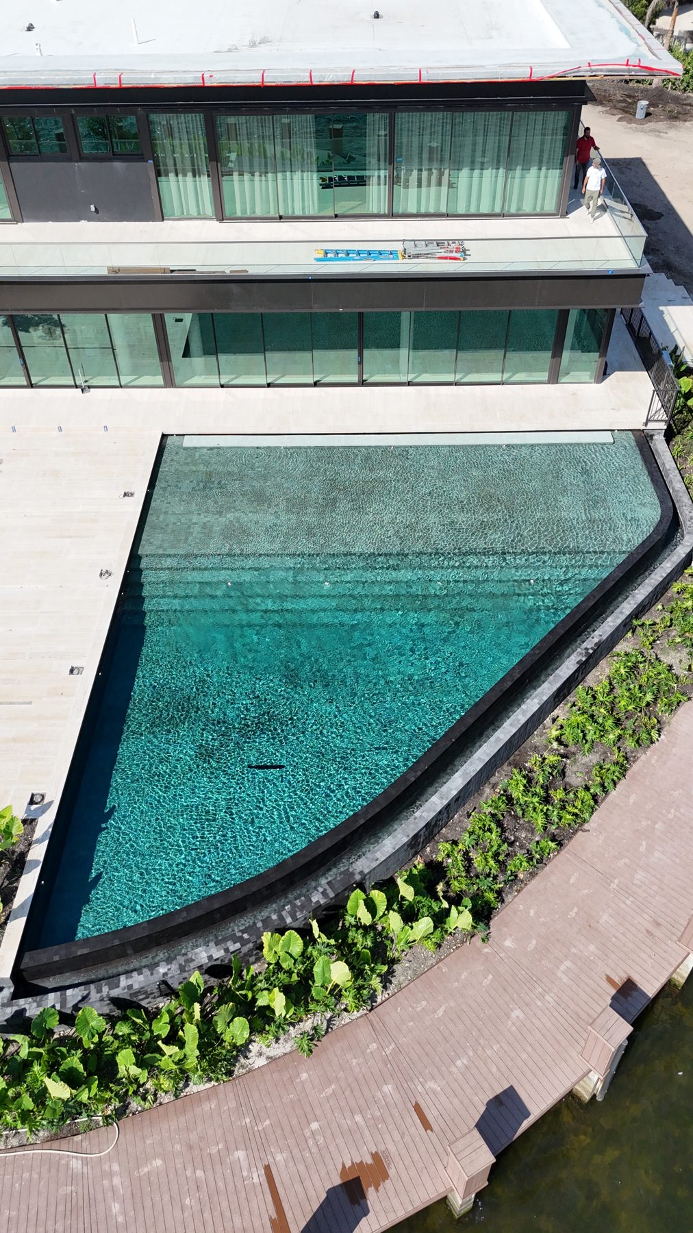 Top-down drone view of the finished pool, lounge and deck