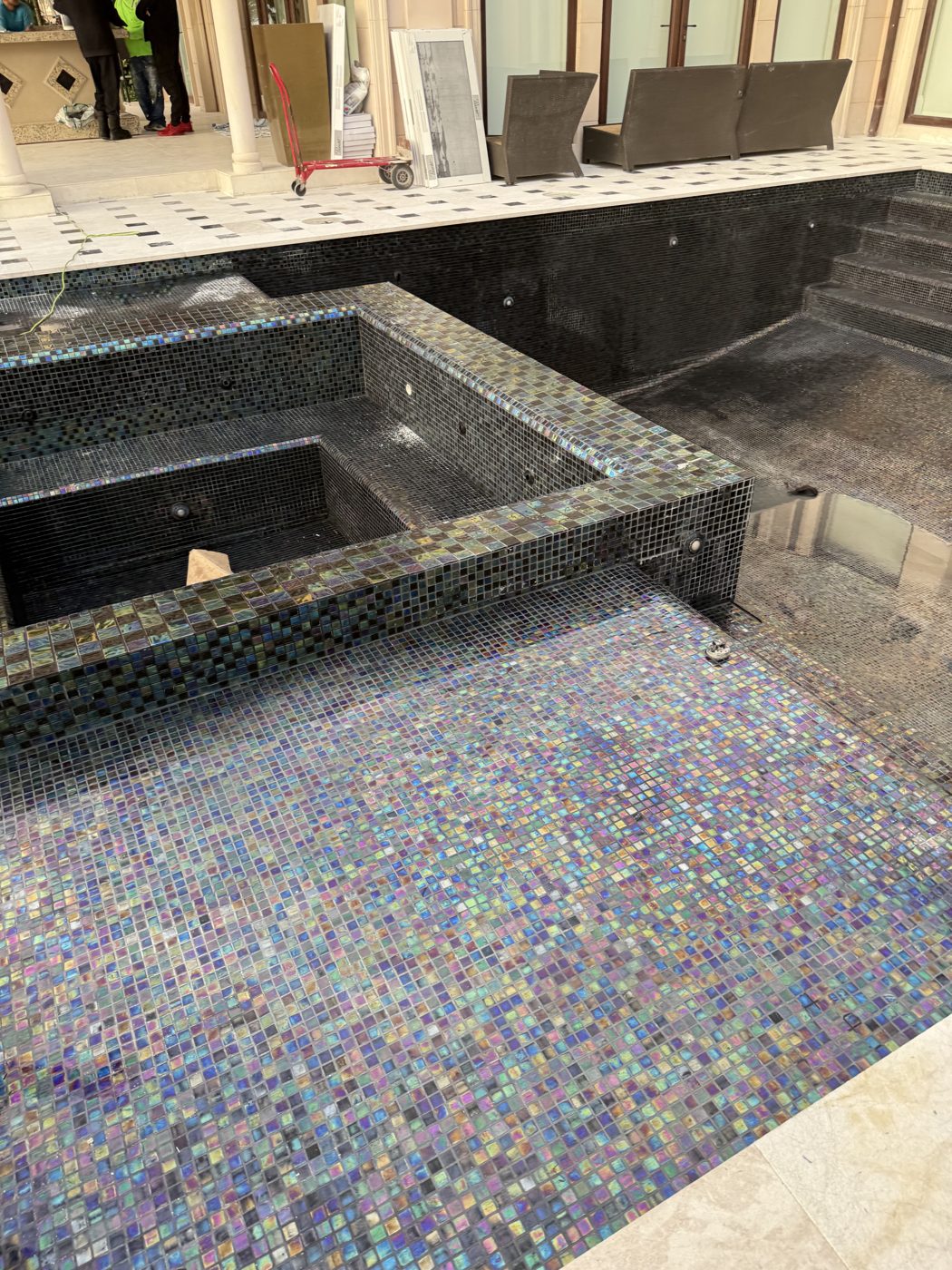 The re-tiled spa and infinity-edge gutter wall before water